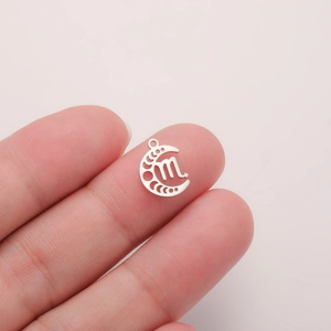 Macro shot of Scorpio constellation moon pendant in polished stainless steel for DIY jewelry