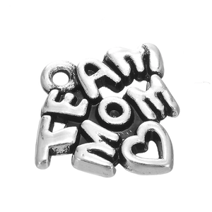 Close-up of vintage silver alloy heart-shaped MOM charm for DIY jewelry and bracelets