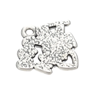 Detailed macro view of antique silver sports charm with unique hammered metal texture