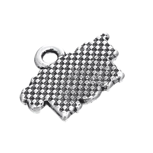 Macro detail of antique silver sports pendant with textured knurled pattern for DIY jewelry