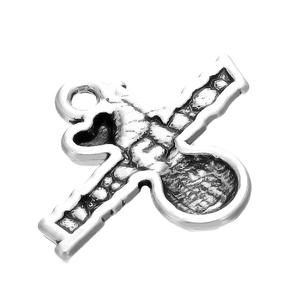 Macro detail of vintage silver alloy key charm with cross design and distressed texture