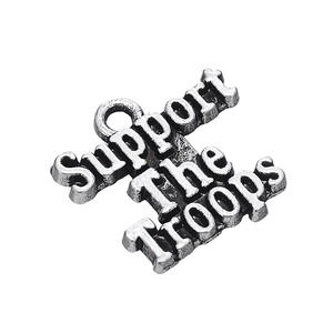 Macro shot of antique silver Support The Troops pendant for DIY jewelry design