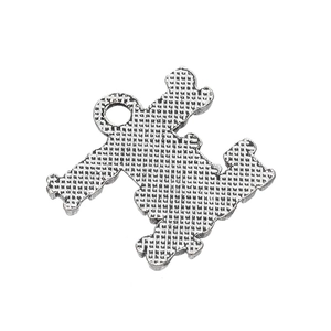 Macro view of silver alloy sports pendant showing grid texture and hanging loop detail