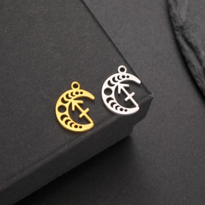 Macro shot of gold and silver crescent moon zodiac pendants with polished finish