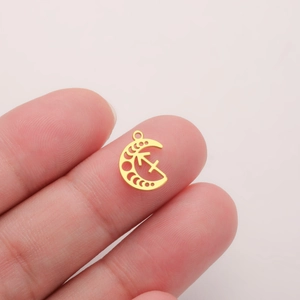 Macro detail of a 18K gold-plated crescent moon pendant with Sagittarius zodiac sign