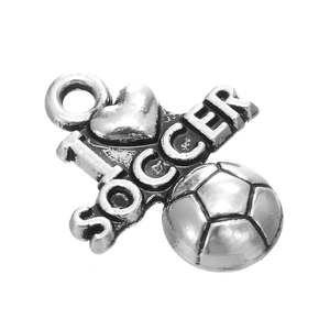 Macro detail of vintage silver soccer ball pendant with I Heart Soccer engraving