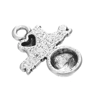 Macro detail of vintage silver heart alloy pendant with a round bezel setting for DIY crafts