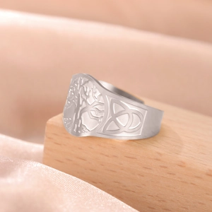 Macro detail of Tree of Life and Celtic knot engravings on a vintage steel band ring
