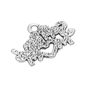 Macro detail of antique silver heart puzzle pendant with engraved text for DIY jewelry