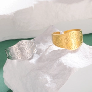 Detailed view of gold and silver Tree of Life rings with Celtic knots on stone