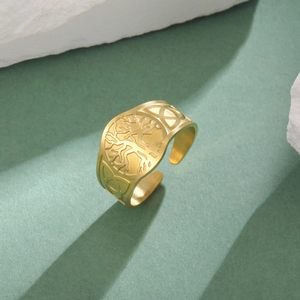 Macro detail of golden Tree of Life engraving and Celtic knot patterns on adjustable ring
