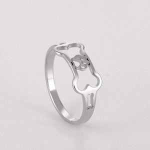 Detailed close-up of hollowed-out dog bone and paw print design on stainless steel ring