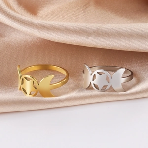 Macro shot of 18K gold and silver triple moon goddess rings on silk background