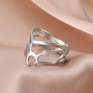 Minimalist stainless steel open ring with hollow crescent design on satin background