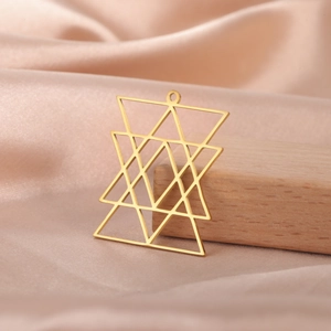 Detailed view of a gold geometric star pendant on champagne silk with wood accent