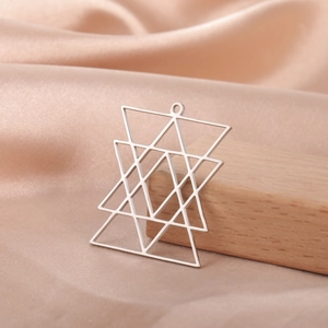 Polished geometric star pendant with overlapping triangles on champagne silk background