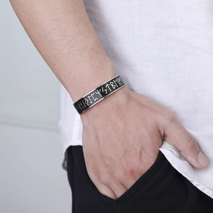Close-up of men's Viking rune cuff bracelet in vintage black and silver steel finish