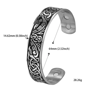 Macro detail of Celtic knot engravings and magnetic therapeutic magnets on silver steel cuff