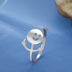 Macro detail of silver stainless steel ring featuring funny stick figure middle finger design