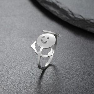 Macro shot of silver hip-hop ring with a rebellious smiley face and hand gesture