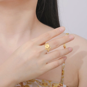 Macro shot of gold funny graffiti middle finger ring highlighting polished metal finish
