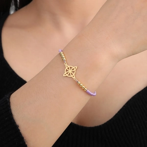 Dettaglio del bracciale con nodo celtico placcato oro 18K e cordino intrecciato viola