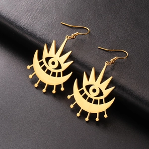 Detail of gold evil eye drop earrings with crescent moon on black leather background