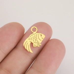 Detailed close-up of a matte gold fish pendant with scale textures for DIY jewelry