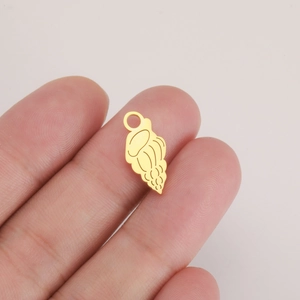 Polished gold jellyfish ocean pendant for DIY jewelry making on human finger for scale