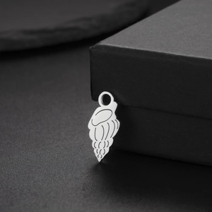 Polished stainless steel jellyfish pendant with spiral sea shell engraving on gift box