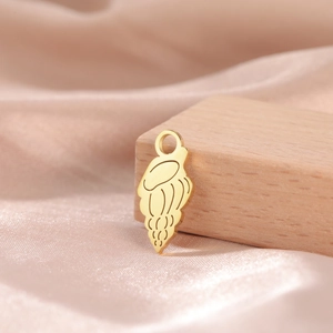 Detailed view of a golden jellyfish pendant with etched texture on silk background