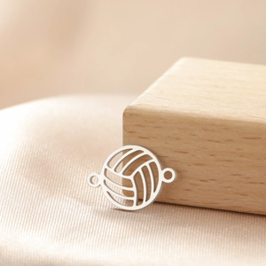 Detailed macro view of silver stainless steel volleyball pendant for DIY jewelry making