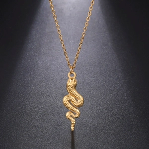 Detailed view of a golden stainless steel snake pendant with intricate scale textures