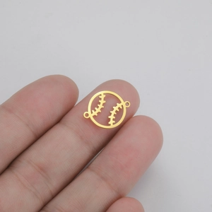 Detailed macro of gold hollow baseball charm connector for DIY jewelry making