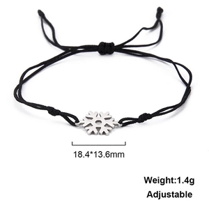 Detail of adjustable snowflake charm bracelet with black cord and silver pendant