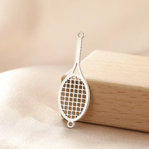 Detailed macro shot of stainless steel tennis racket pendant with hollow mesh and dual rings