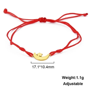 Detailed view of adjustable red cord bracelet with gold star and moon charms