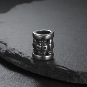 Retro stainless steel skull beads for DIY jewelry making on black slate surface