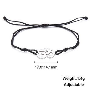Detail view of woven Om symbol bracelet with adjustable strap and silver metal charm