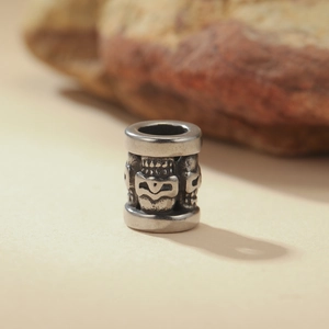 Macro view of vintage stainless steel skull bead with embossed patterns for DIY jewelry