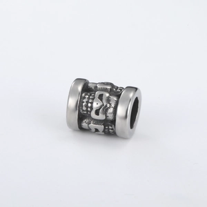 Detail shot of vintage stainless steel skull bead with embossed punk gothic carvings