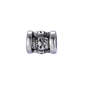 Macro shot of retro stainless steel skull charm bead with intricate vintage carvings