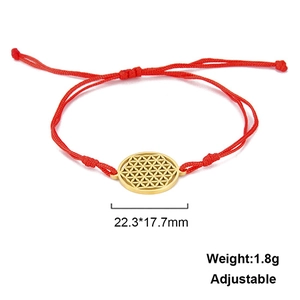 Macro detail of red woven bracelet with adjustable knot and golden flower of life charm