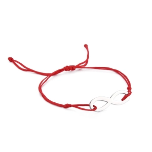 Close-up of a red woven rope bracelet featuring a polished silver infinity symbol charm