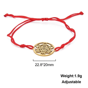 Detail of red braided rope bracelet with adjustable cord and gold Metatron cube pendant