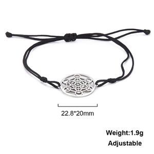 Macro shot of Metatron cube pendant on adjustable black braided stainless steel bracelet