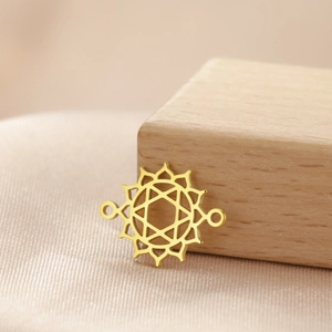 Gold stainless steel mandala connector pendant with double loops on silk background