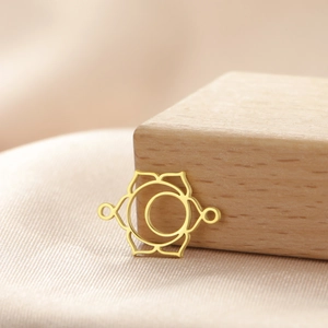 Macro shot of gold lotus moon charm connector with dual rings for DIY jewelry making