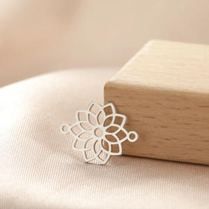 Macro shot of silver hollow lotus flower pendant connector for DIY jewelry making