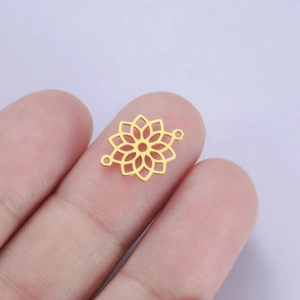 Detail of a small gold hollow mandala flower pendant connector for DIY jewelry making